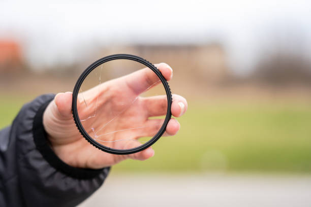 istock DSLR camera with broken protective glass for lens. Cracked photo-filter 1505216793