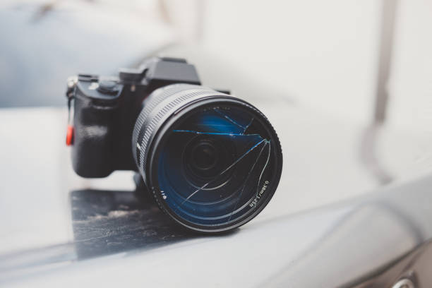 istock DSLR camera with broken lens filter. Cracked photo-filter 1505216811