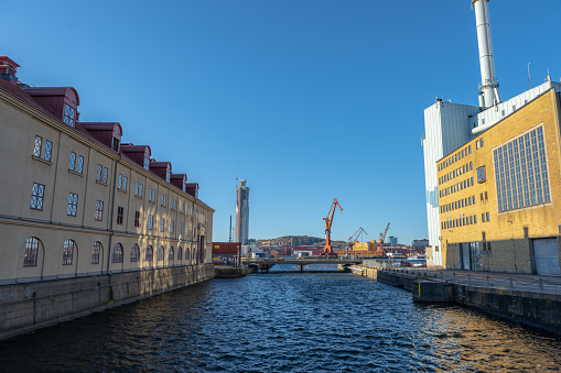Gothenburg, Sweden - March 05 2023: Karlatornet and old wharf cranes oposite from Lagerhuset and Rosenlundsverket.