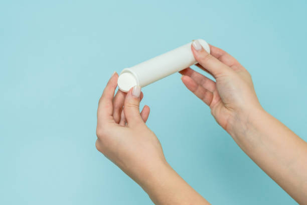 istock Packaging for vitamins, pills with tablet in hand. White tube. Mockup 1505221301