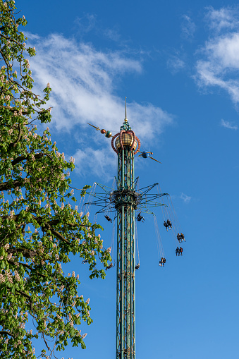 Copenhagen, Denmark - May 28, 2023: Star Flyer Ride (Himmelskibet) at the historic Tivoli Gardens Amusement Park.