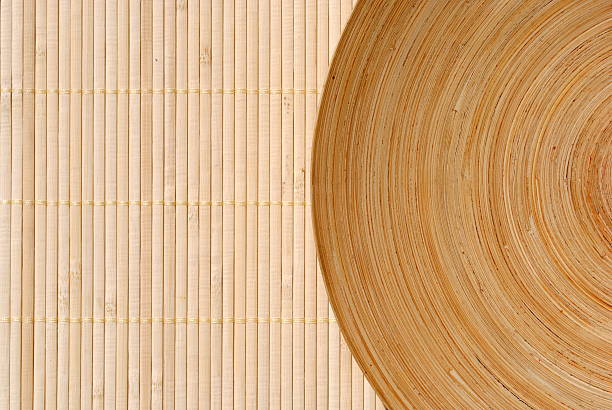 istock high definition round wooden dish on bamboo background 150522356