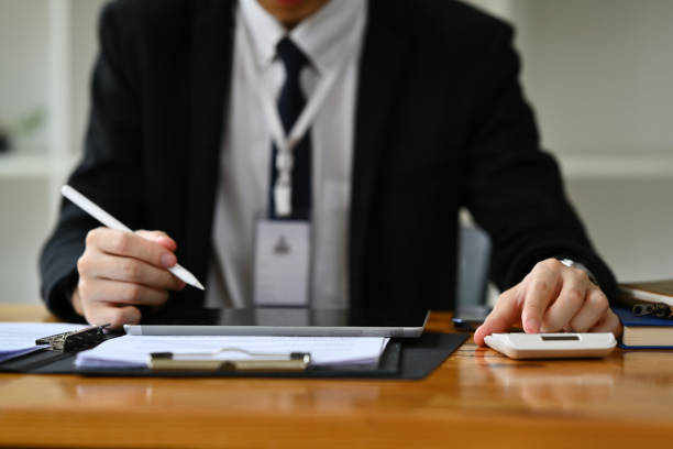 istock Professional businessman analyzing sales statistics document, using laptop at wooden office desk. 1505230329