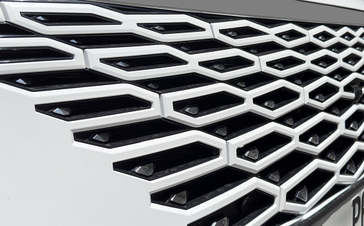 Radiator grille pattern. Car radiator grill close up. Chrome grill of big powerful car engine.