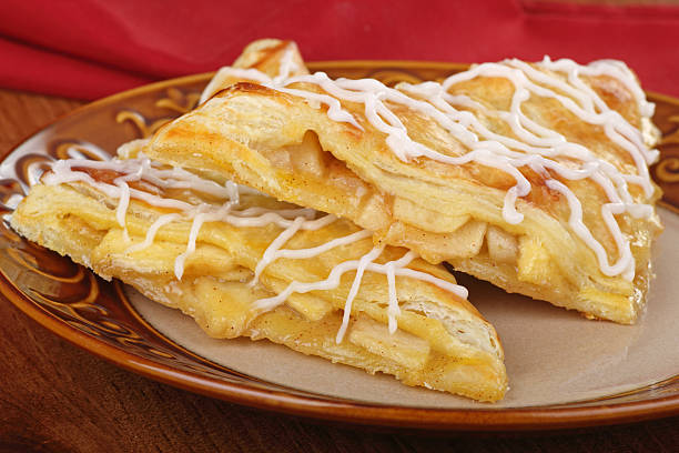 Two Apple Turnovers Two apple turnover pastries on a plate apple strudel stock pictures, royalty-free photos & images