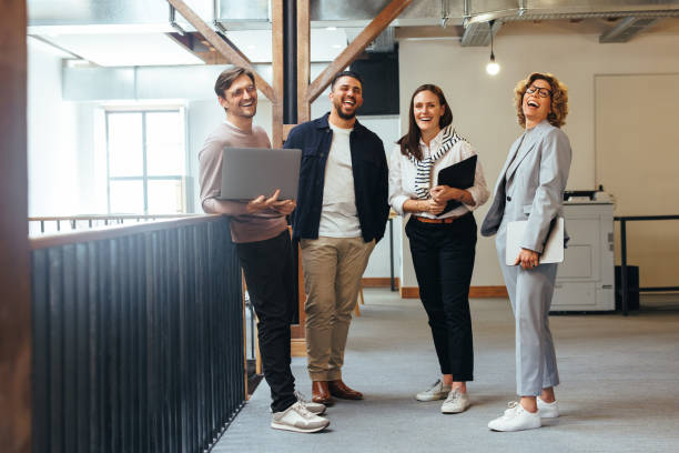 istock Successful business team laughing while standing together 1505239859