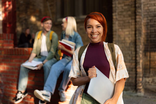istock Happy redhead female student in front of school building. 1505241461