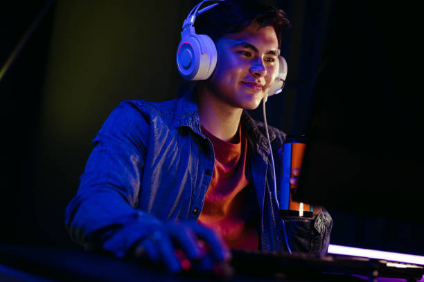 istock Computer gamer holding an energy drink as he plays a video game on a pc 1505242209