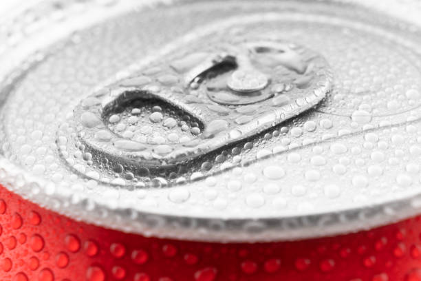 Red aluminum cans with fresh water drops texture background. Water droplets on soda can macro shot stock photo