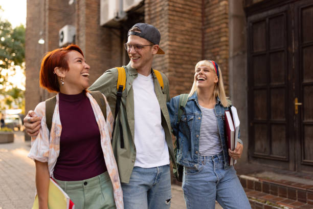 istock Happy embraced students talking while taking a walk on the street. 1505244970