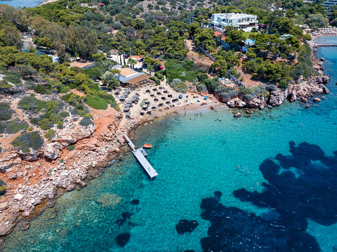 Aerial view of the small beach Thespidos at the bay of Vouliagmeni, Athens, Greece, with shining turquoise sea