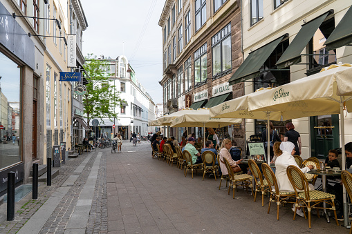 Copenhagen, Denmark - May 31, 2023: People sitting outside the pastry shop La Glace in the historic city centre.