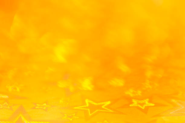 Stars abstract lights, yellow blurred background. Blurred yellow-orange background.