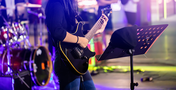 Thailand Bangkok, June 19, 2023 : Teenagers join together to play music on Yai Siam Square Road. It is an activity for the young generation to express themselves through music held in the afternoon and evening of each day.