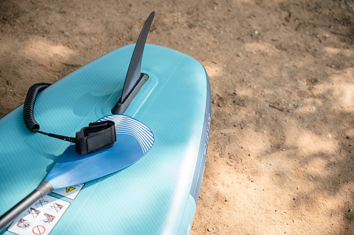 Close-up of paddleboard laying on the ground