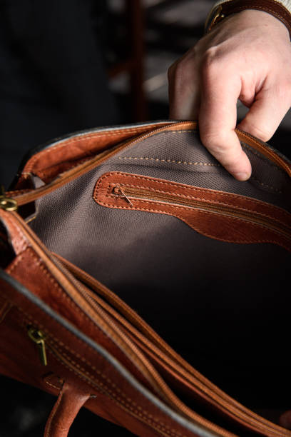 istock top view of open empty leather bag in mans hands 1505271755