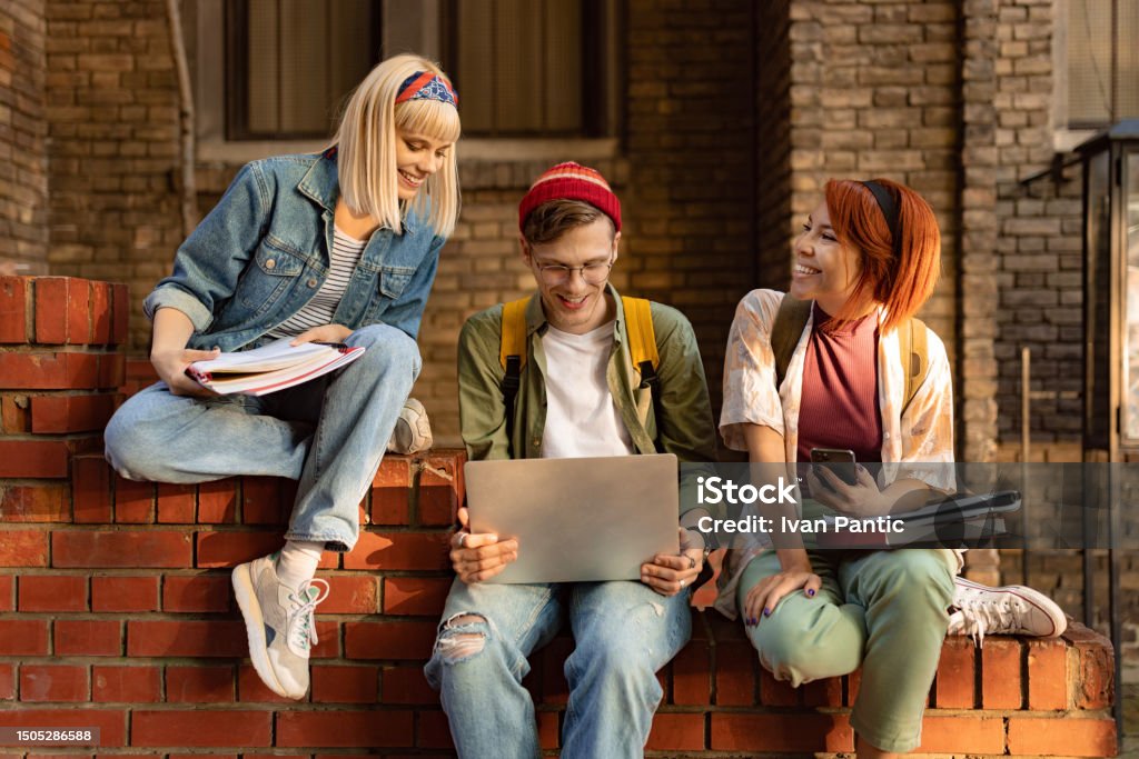 Students On Elearning Happy Students Elearning Over A Computer On The Street Stock Photo ...