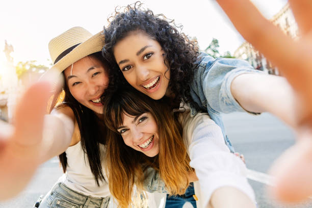 istock Three multiracial young women having fun on city street 1505295145