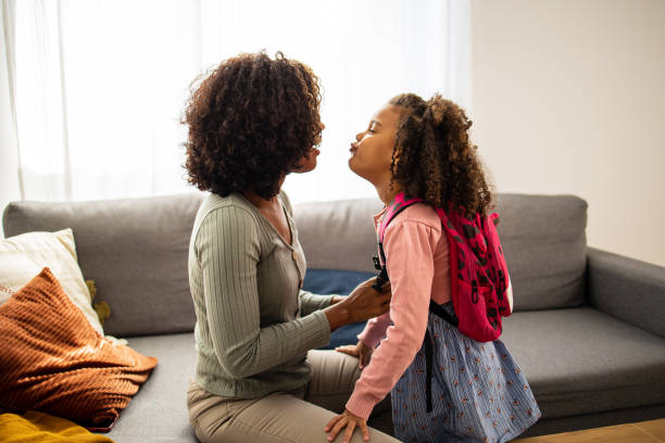 istock Mother helping her daughter to get ready for school 1505312681