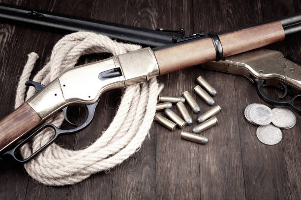 istock Old west guns. Lever action repeating rifles with ammunition 1505312682