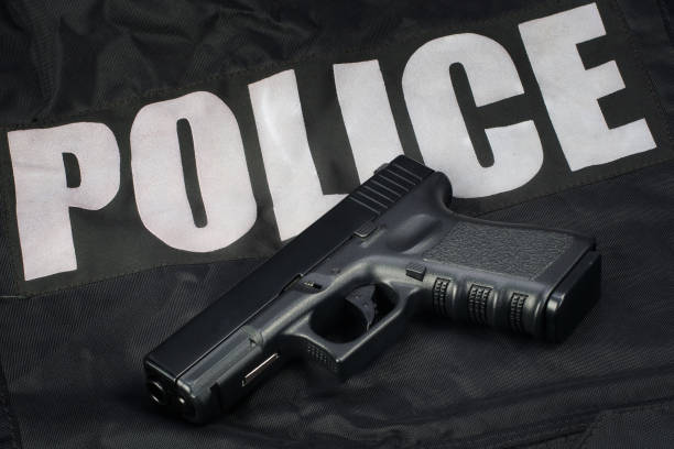 istock Police hand gun on black uniform 1505313211