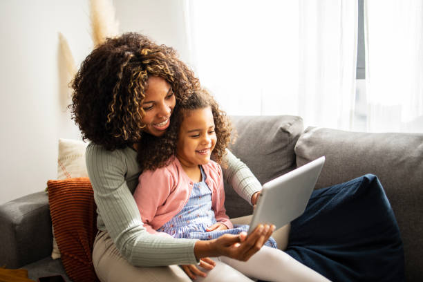 istock Mother and daughter using digital tablet for video call 1505315450