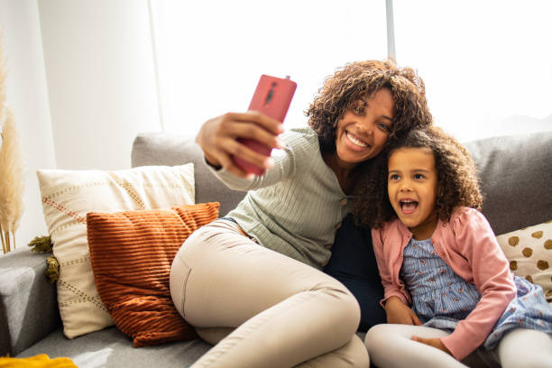 istock Mother and daughter at home taking selfie 1505317249
