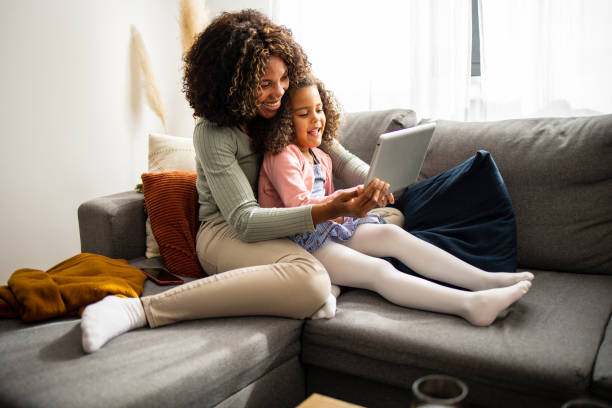 istock Mother and daughter using digital tablet for video call 1505321124