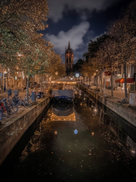 October 2021 - Delft, the Netherlands: Nighttime reflection of light decoration near the Old Church (Oude Kerk) in Delft.