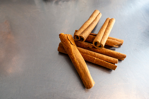 Cinnamon sticks on metal table