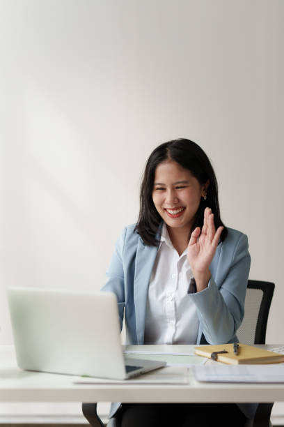 Smiling Asian Accountant person analyze financial report and studies annual figures, analyzes profits