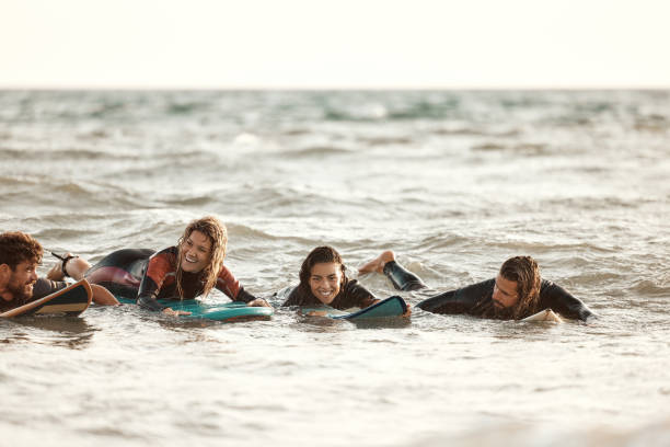 istock Happy surfers having fun in summer day at sea. 1505341924