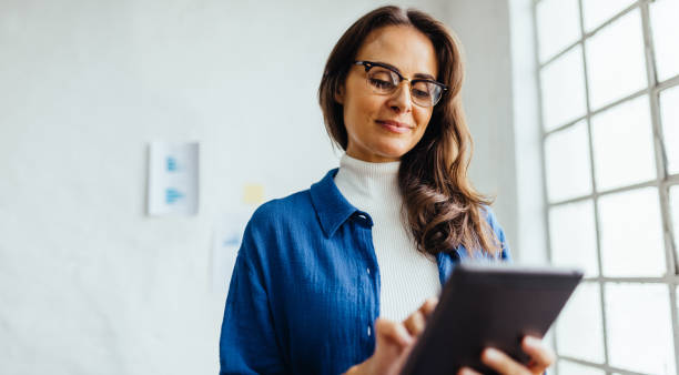 istock Focused business woman working from a digital tablet in her office 1505353628