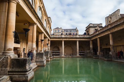 Bath, United Kingdom - November 2, 2017: Roman baths of Bath, Somerset, tourists visit one of the most popular landmarks of the city