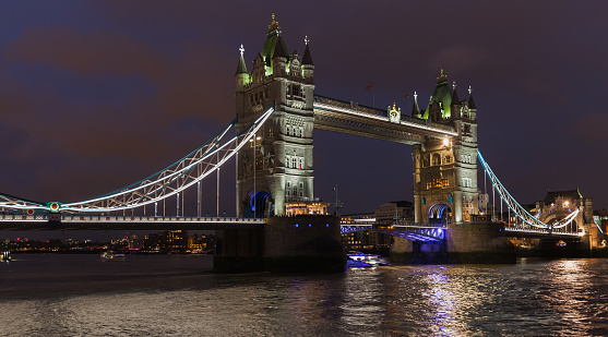 London, United Kingdom - November 04, 2017: Illuminated Tower Bridge at night with colorful reflections in water of Thames river