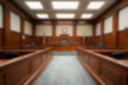 Blurred background of an empty courtroom.