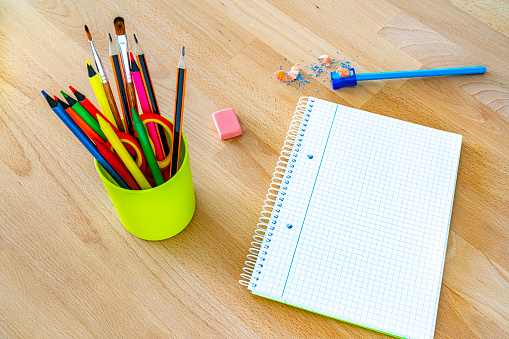 Blank note pad and pencil holder. Back to school concept.