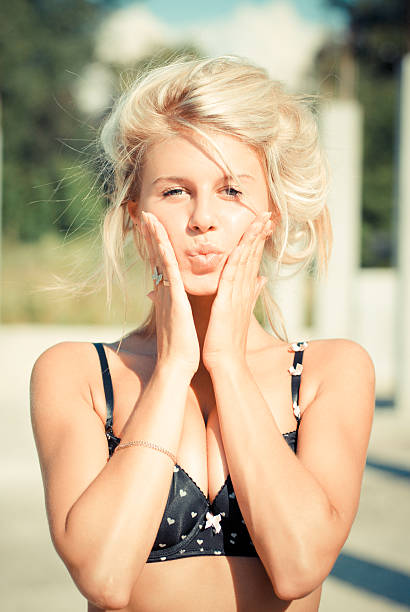 istock Young beautiful blond woman touching cheeks put lips in kiss 150536686