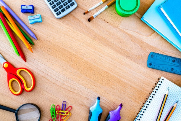 istock School supplies border on wooden table. Copy space 1505367183