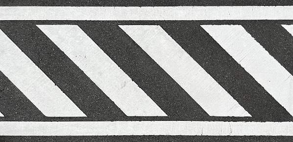 Asphalt road texture with white stripe, Roadway background texture and a Traffic sign. Traffic lines on the street.