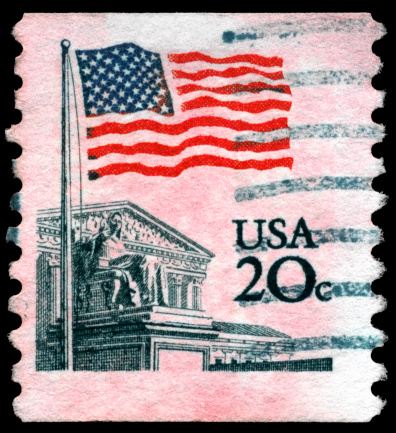 Image of USA flag and White House Stamp with black background.