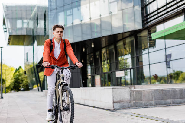 istock Man rides bicycle by business building 1505383390