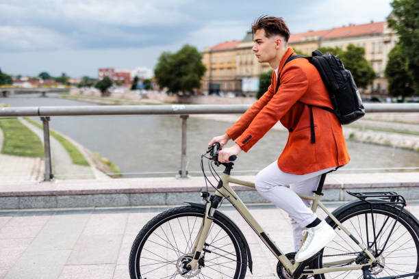 istock Businessman with backpack rides bicycle in the city 1505387217