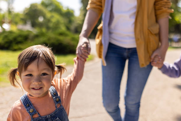 istock Mother walking in a public park with her daughter 1505389994
