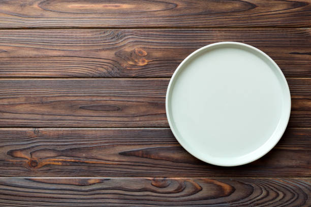 istock Top view of empty blue plate on wooden background. Empty space for your design 1505407187