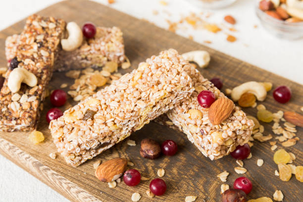 istock Various granola bars on table background. Cereal granola bars. Superfood breakfast bars with oats, nuts and berries, close up. Superfood concept 1505407191