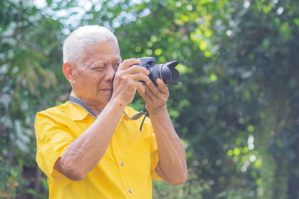 istock Senior man taking using digital camera photography while standing outdoors. 1505416080