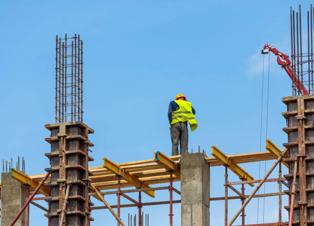 istock A male construction worker stands on reinforced concrete beams at a height. 1505420021