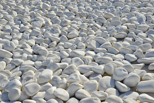 White stones pebbles for decoration at luxury sea view resort on Santorini Island, Greece.
