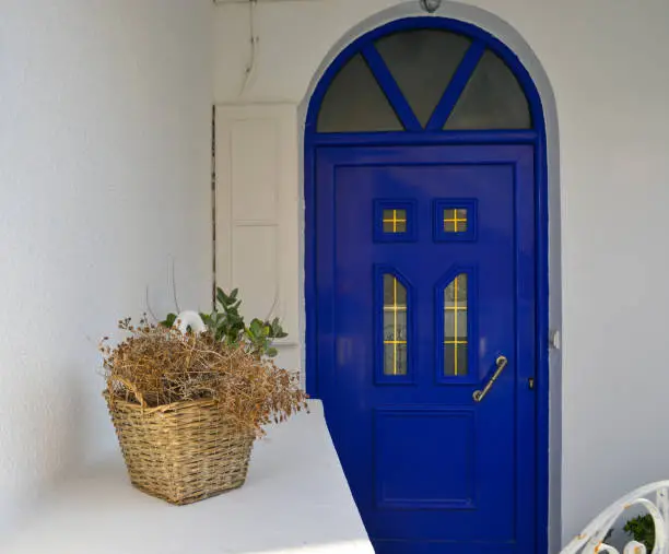 Blue wooden door of typical house on Santorini Island, Greece.